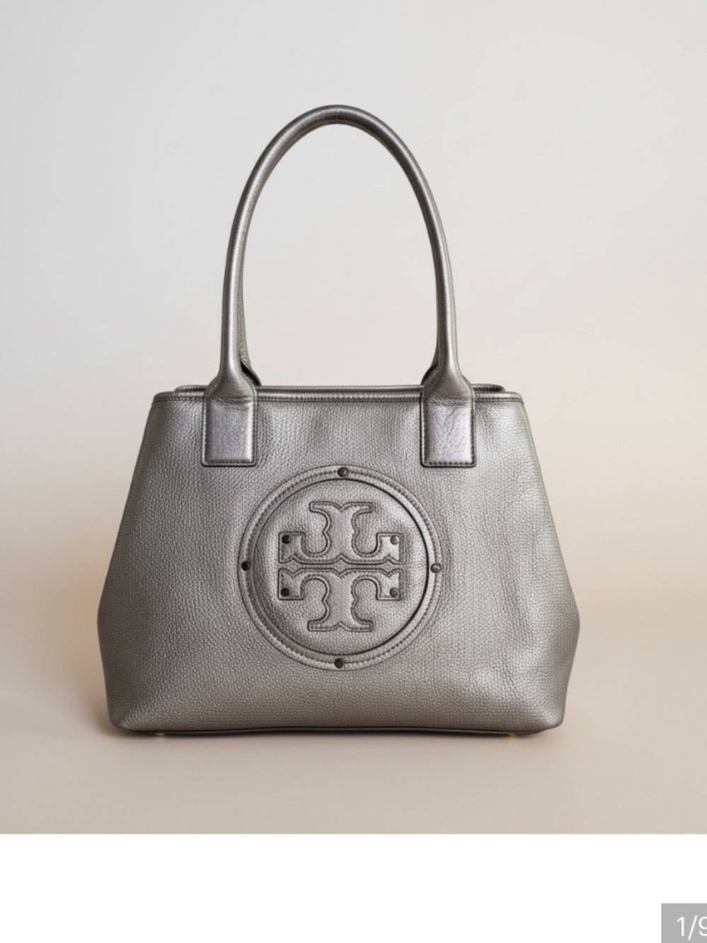 Metallic Tory Burch hand bag like new condition inside and out.